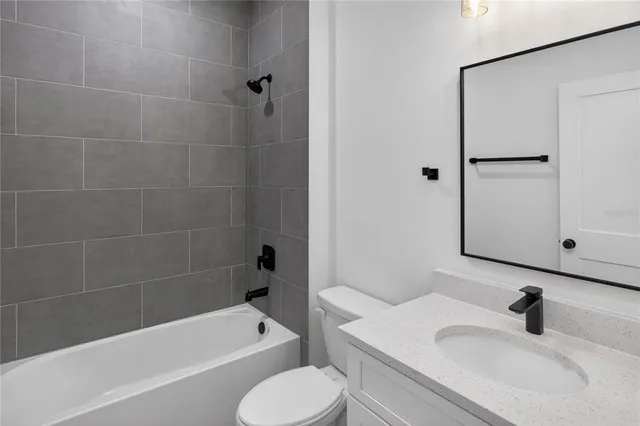a bathroom with a sink toilet bathtub and vanity