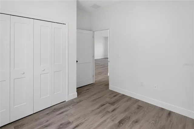 a view of a room with wooden floor