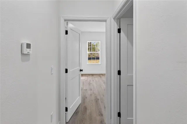 a view of a room with wooden floor and cabinet