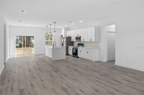 a view of a kitchen with a sink and a refrigerator