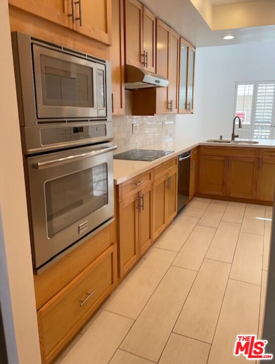 4338 Redwood Avenue, Unit B313 Marina del Rey, CA 90292 - Photo 12 of 31 a kitchen with stainless steel appliances a stove microwave and sink