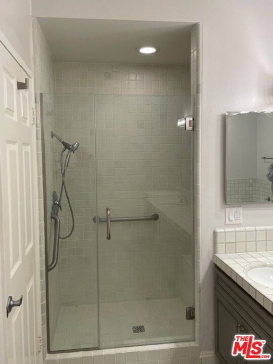 4338 Redwood Avenue, Unit B313 Marina del Rey, CA 90292 - Photo 20 of 31 a bathroom with a granite countertop shower a sink and a mirror