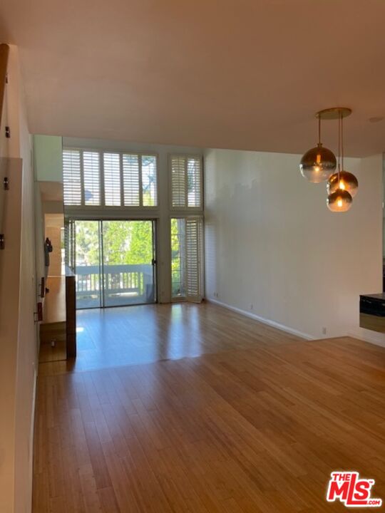 4338 Redwood Avenue, Unit B313 Marina del Rey, CA 90292 - Photo 4 of 31 wooden floor in an empty room with a window