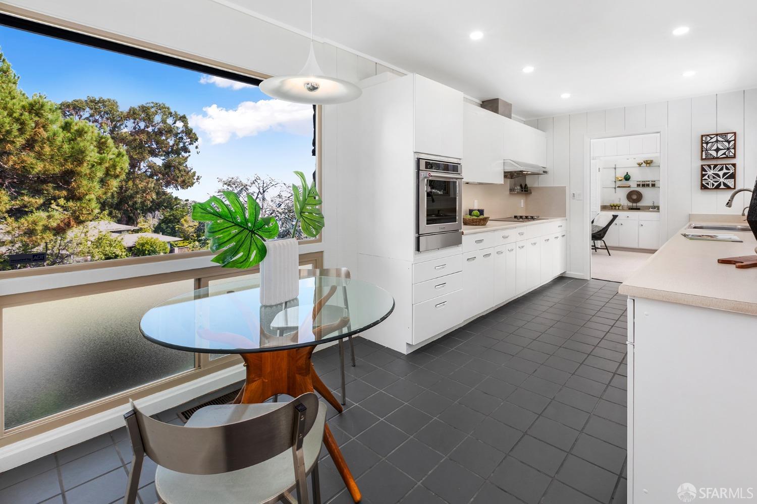406 Middle Road Belmont, CA 94002 - Photo 16 of 67 a kitchen with stainless steel appliances kitchen island granite countertop a sink a stove a table and chairs