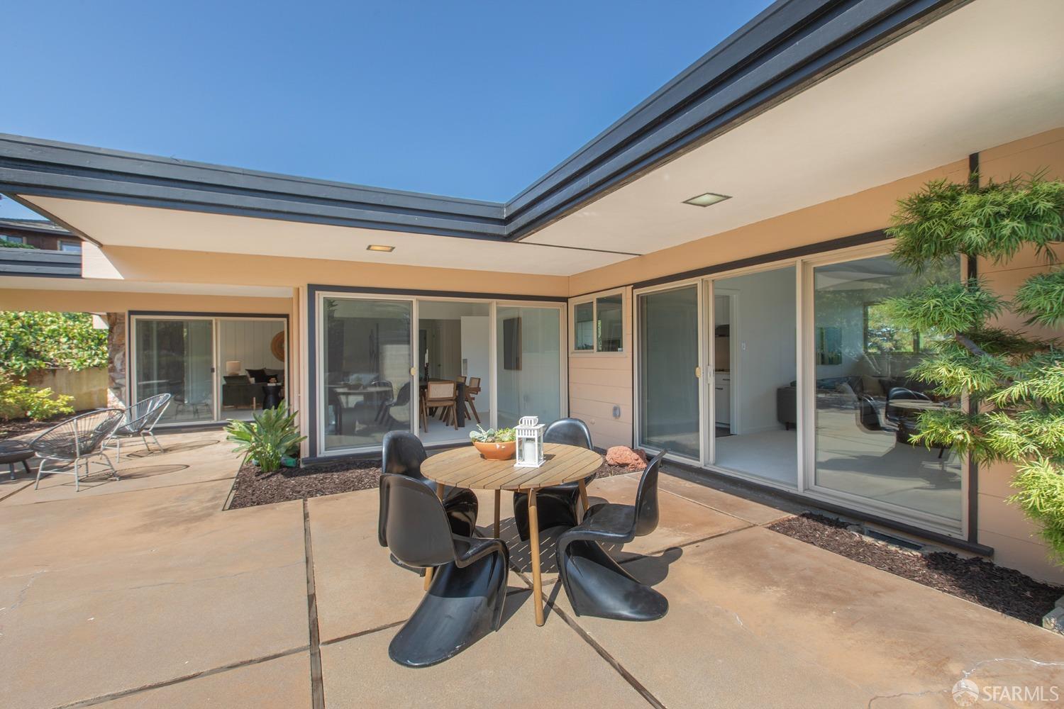 406 Middle Road Belmont, CA 94002 - Photo 28 of 67 a patio with a table and chairs and potted plants
