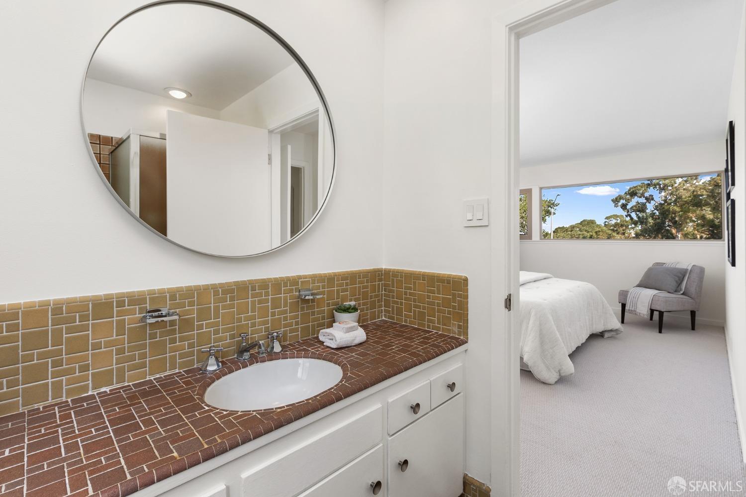 406 Middle Road Belmont, CA 94002 - Photo 38 of 67 a bathroom with a granite countertop sink and a mirror