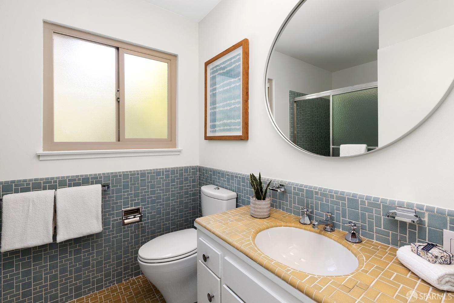 406 Middle Road Belmont, CA 94002 - Photo 42 of 67 a bathroom with a granite countertop toilet sink and mirror