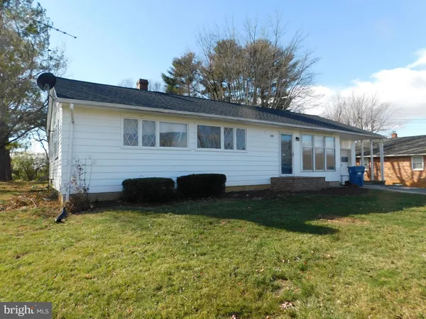 a front view of house with yard and green space