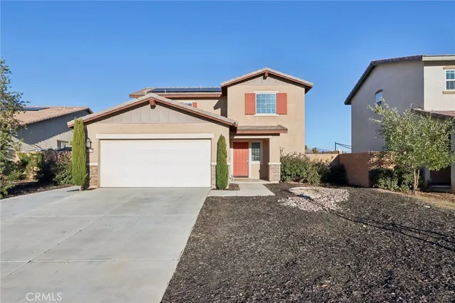a view of a house with a yard and garage