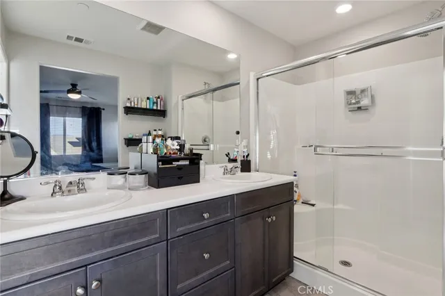 a view of walk in closet with clothes