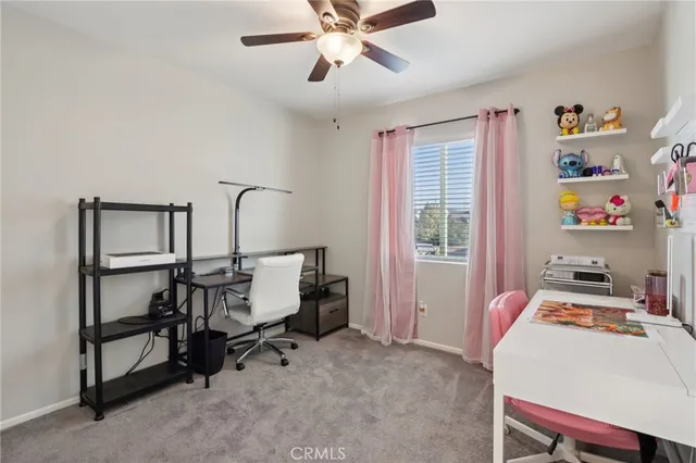 a bedroom with a bed and a ceiling fan