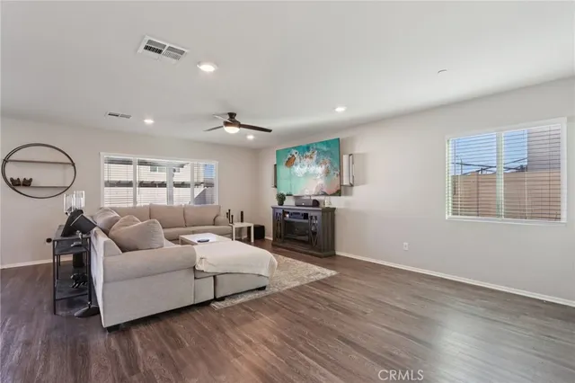 a living room with furniture and kitchen view