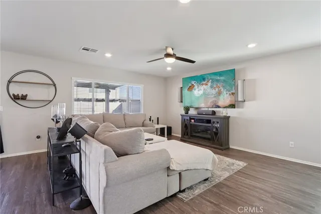 a kitchen with stainless steel appliances granite countertop a refrigerator oven a sink dishwasher a dining table and chairs with wooden floor