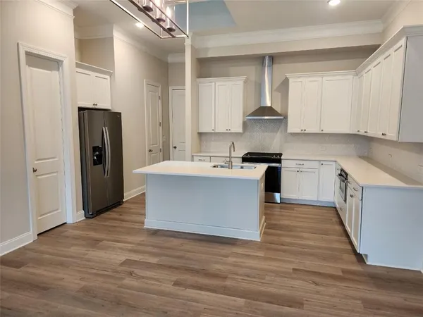 a kitchen with stainless steel appliances granite countertop a white stove top oven and cabinets