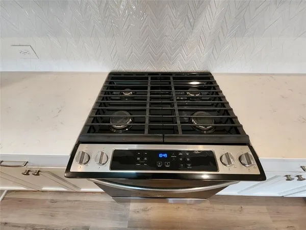 a kitchen with a sink a stove and cabinets