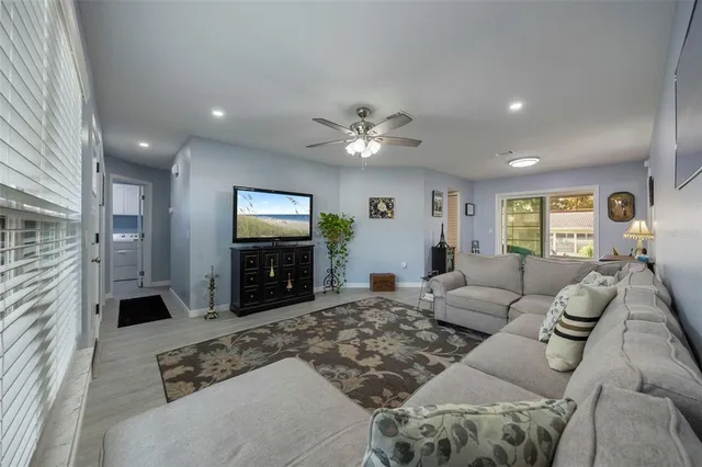 a living room with furniture a rug and a chandelier
