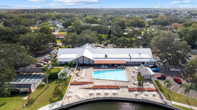 an aerial view of residential houses with outdoor space and swimming pool