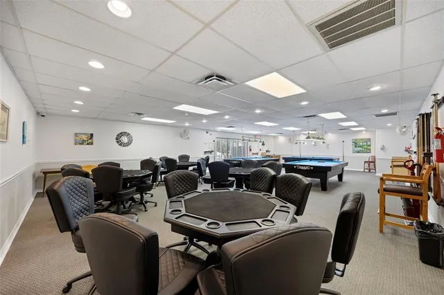 a room with pool table and a table