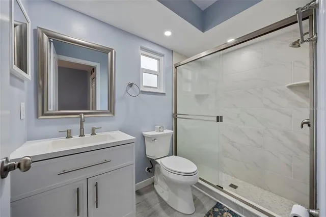 a bathroom with a sink a toilet and shower