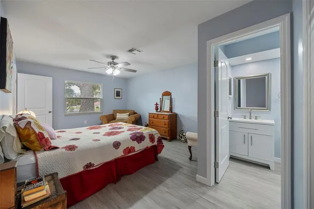 a bedroom with a large bed and a chandelier