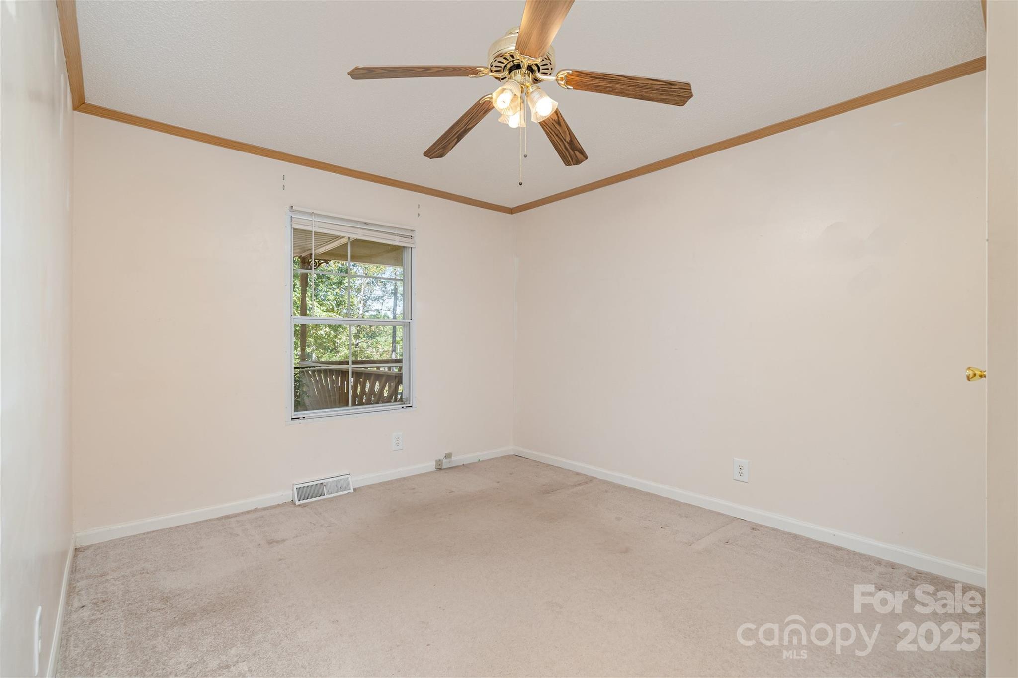 1979 Center Road Chester, SC 29706 - Photo 23 of 38 an empty room with a window and a fan