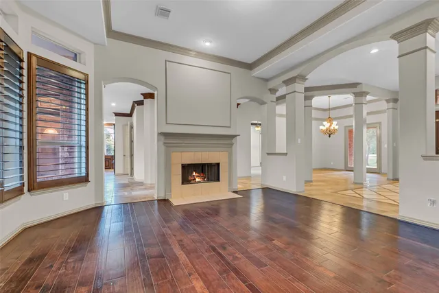 a view of a livingroom with wooden floor and a fireplace