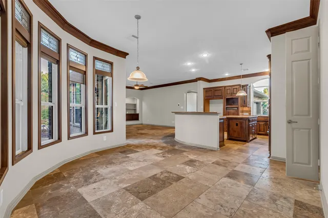 a view of a living room and entry way to kitchen
