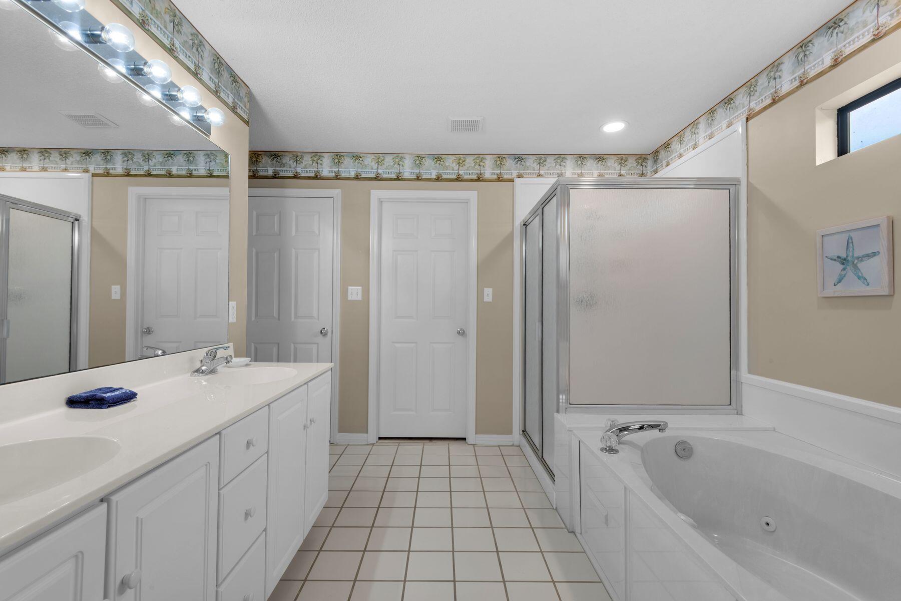 77 Golf Tee Lane, Unit 27G Miramar Beach, FL 32550 - Photo 13 of 29 a bathroom with a sink a mirror and a bathtub