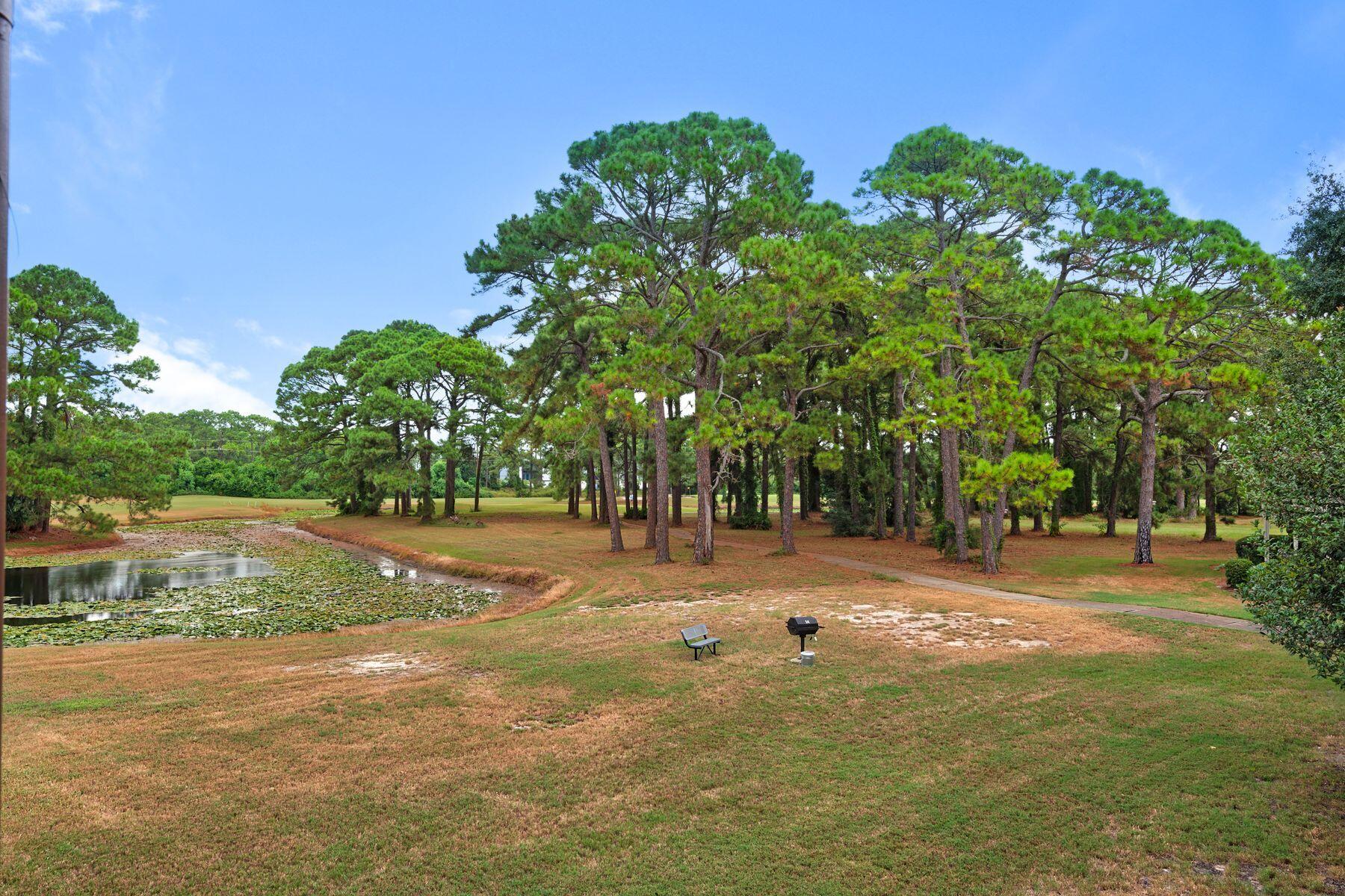 77 Golf Tee Lane, Unit 27G Miramar Beach, FL 32550 - Photo 16 of 29 a backyard of a house with lots of green space and fountain