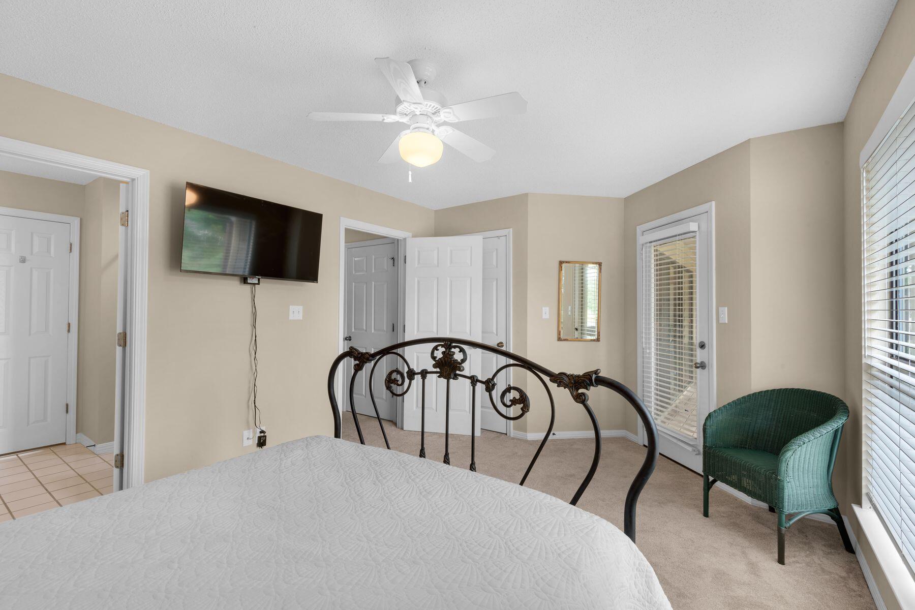 77 Golf Tee Lane, Unit 27G Miramar Beach, FL 32550 - Photo 19 of 29 a bedroom with a bed a mirror and a flat tv screen