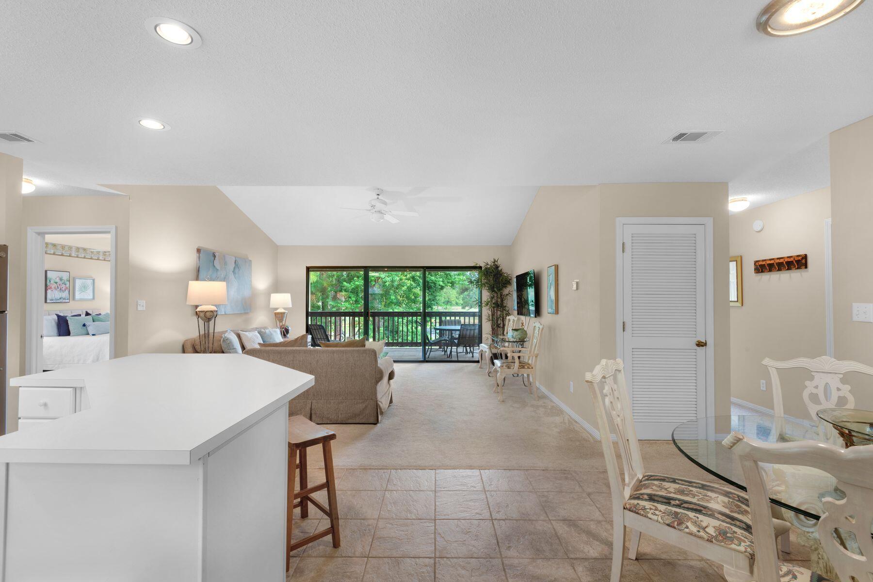 77 Golf Tee Lane, Unit 27G Miramar Beach, FL 32550 - Photo 2 of 29 a large kitchen with a table and chairs in it