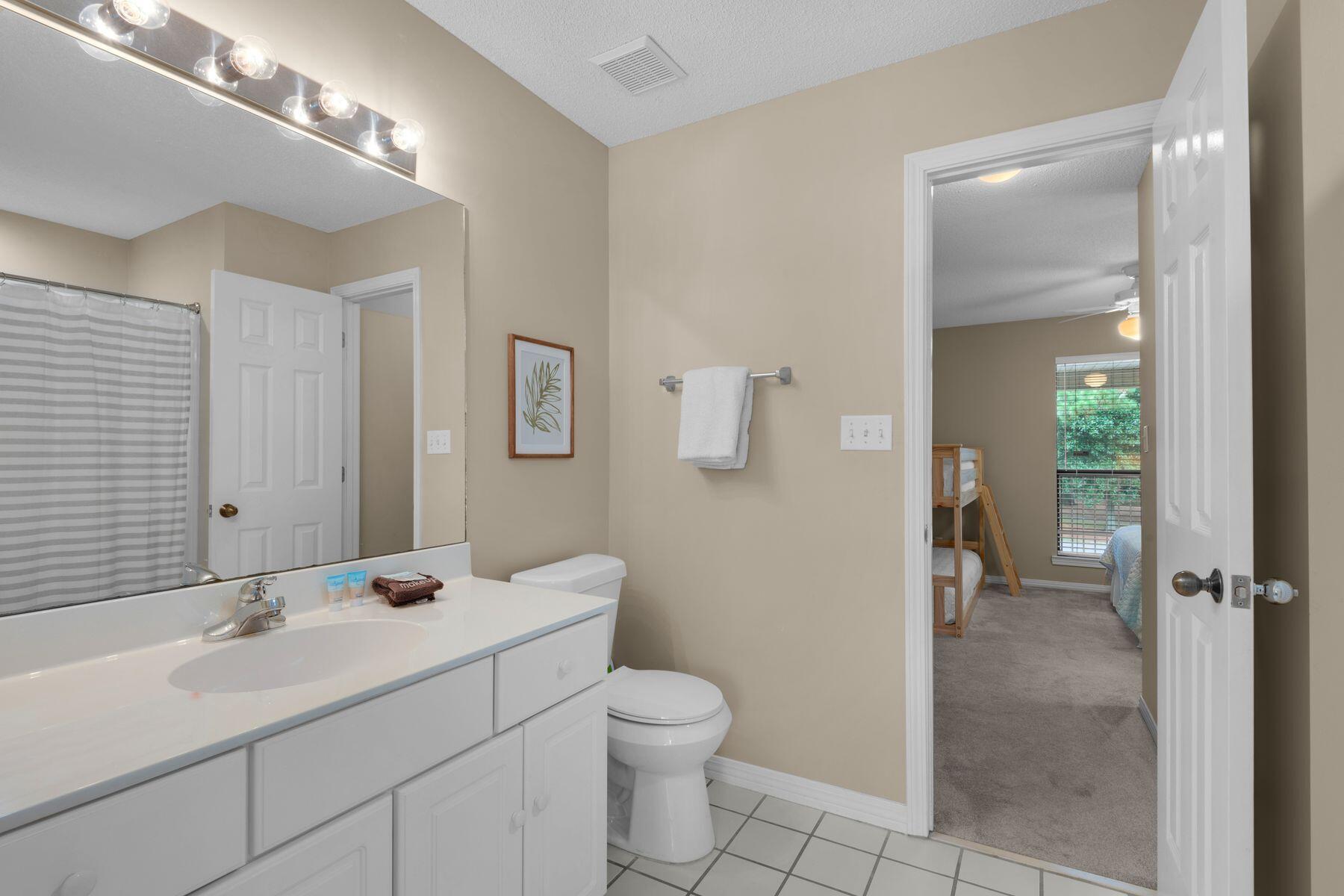 77 Golf Tee Lane, Unit 27G Miramar Beach, FL 32550 - Photo 21 of 29 a bathroom with a toilet sink and mirror