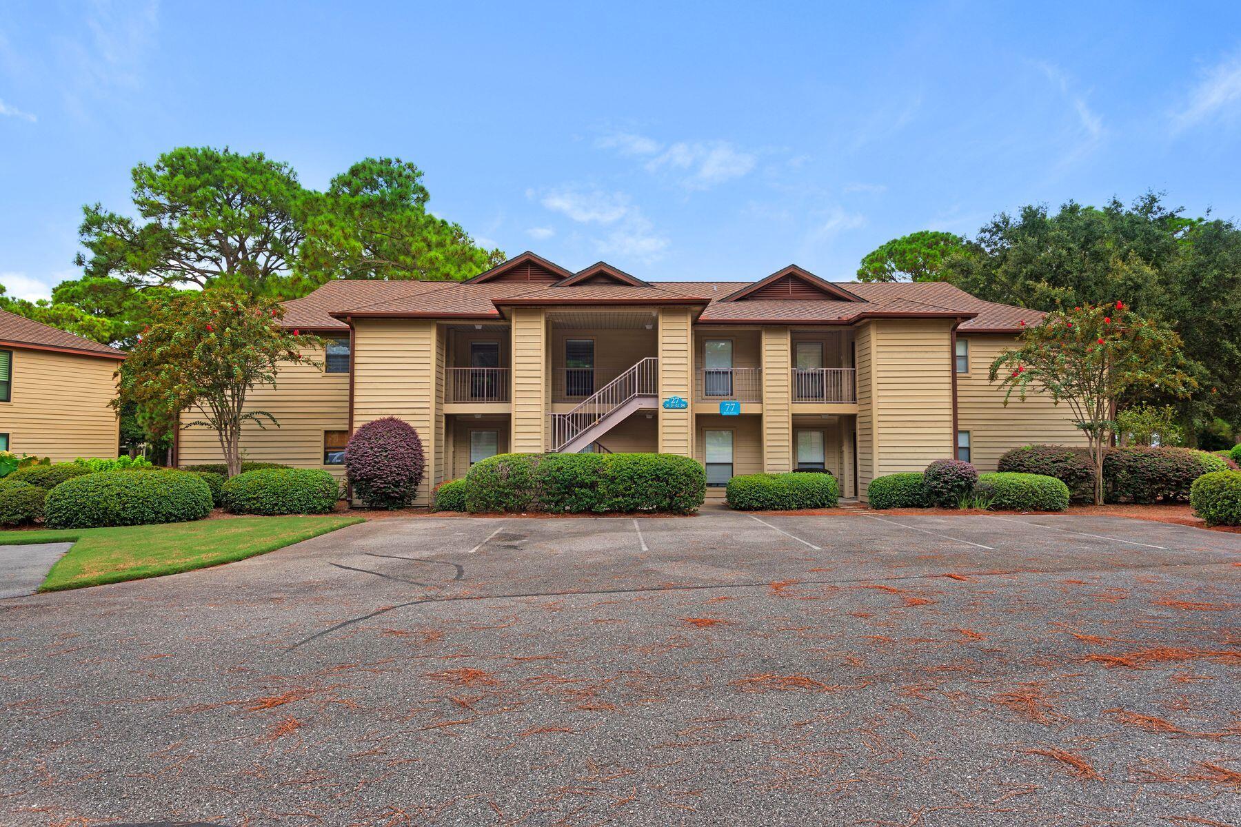 77 Golf Tee Lane, Unit 27G Miramar Beach, FL 32550 - Photo 29 of 29 a front view of a house with a garden and trees
