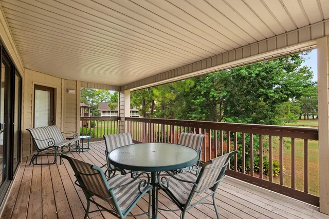 a view of a patio with a table chairs and backyard
