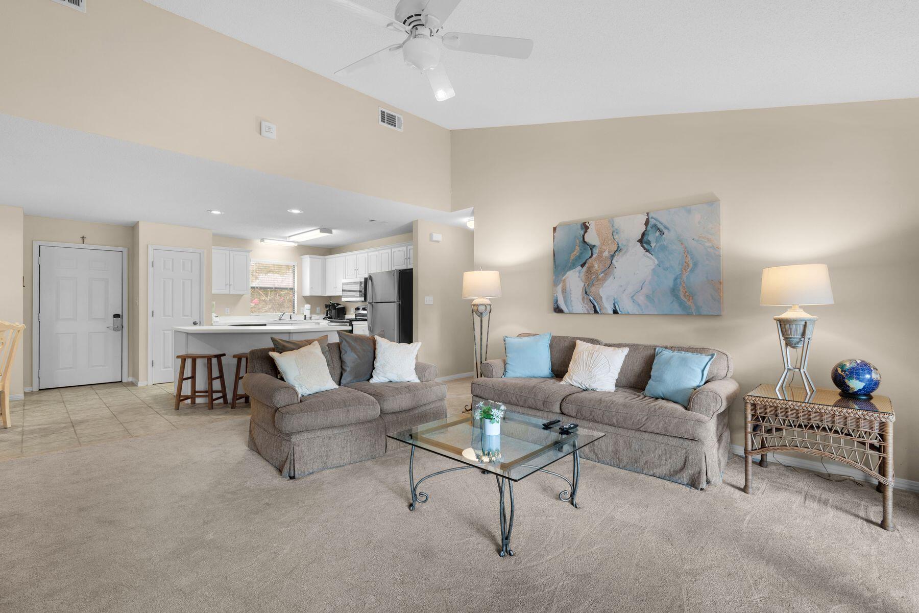77 Golf Tee Lane, Unit 27G Miramar Beach, FL 32550 - Photo 8 of 29 a living room with furniture and a dining table with kitchen view
