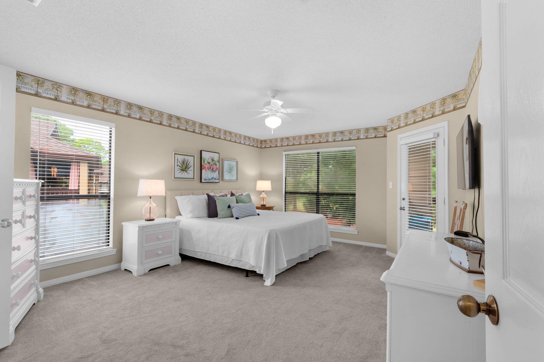 77 Golf Tee Lane, Unit 27G Miramar Beach, FL 32550 - Photo 10 of 29 a bed room with a bed and three large window