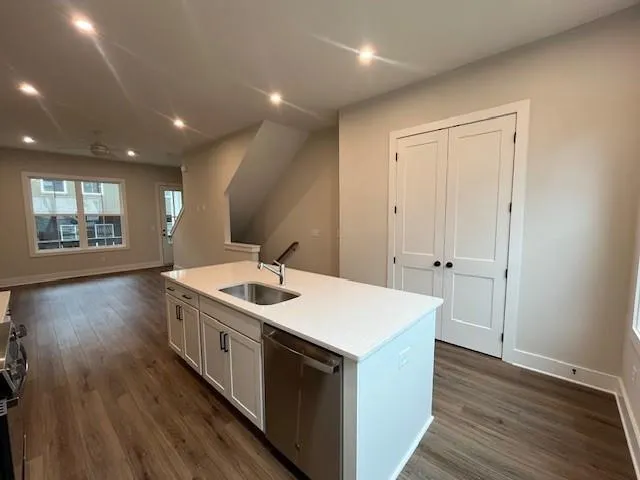 a kitchen with stainless steel appliances a white stove refrigerator sink and cabinets