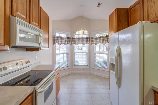 a kitchen with stainless steel appliances granite countertop a refrigerator and a stove
