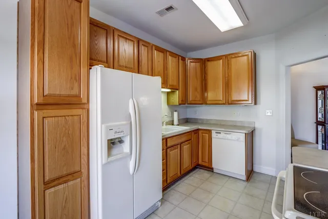 a kitchen with a sink cabinets and utility room