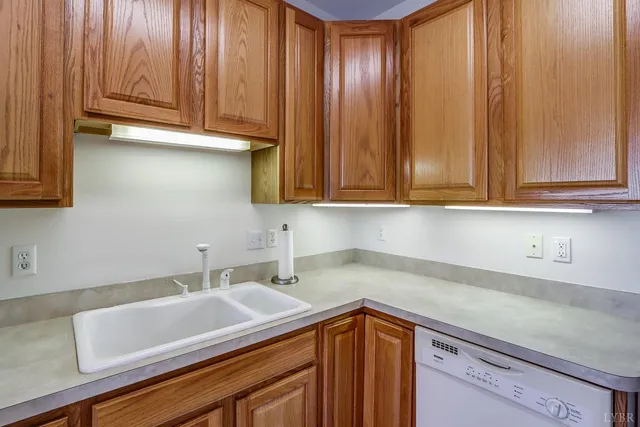 a kitchen with a sink cabinets and wooden floor
