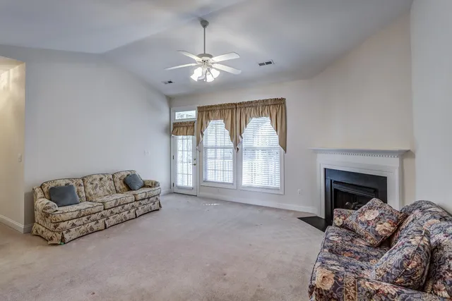 a living room with furniture a window and a fireplace