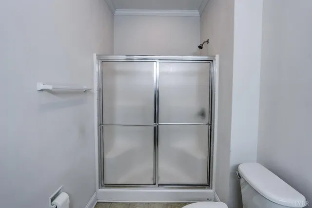 a bathroom with a shower and toilet