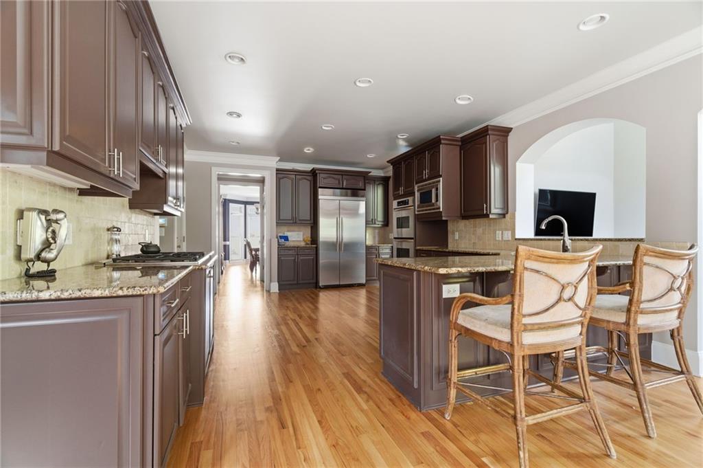 1607 Oak Grove Road Decatur, GA 30033 - Photo 16 of 71 a kitchen with stainless steel appliances kitchen island granite countertop a stove a sink and a refrigerator