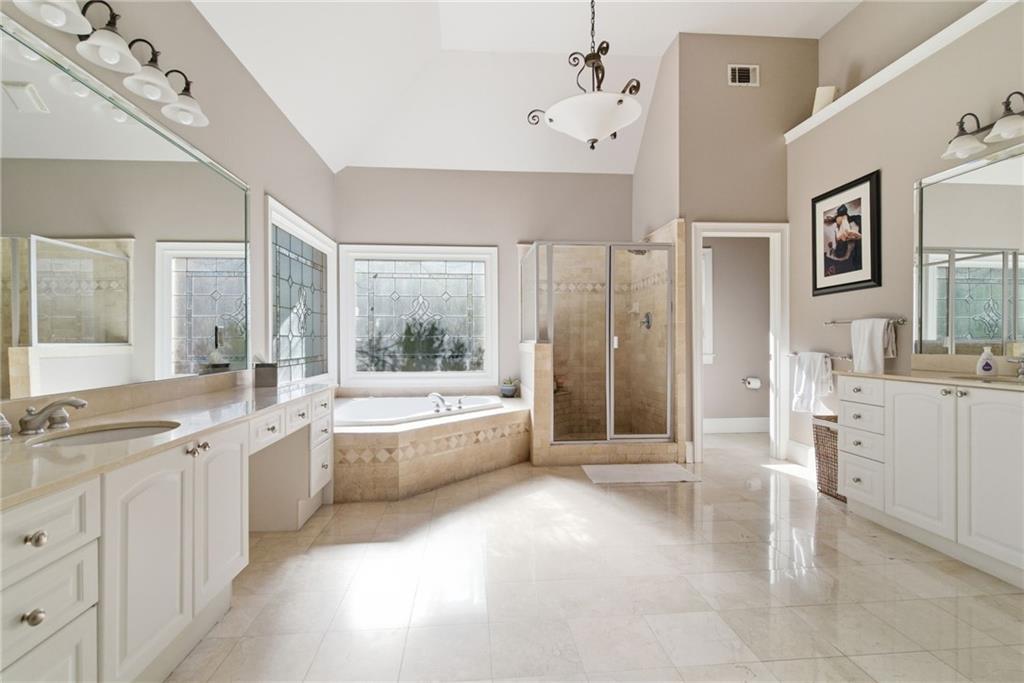 1607 Oak Grove Road Decatur, GA 30033 - Photo 23 of 71 a large white bathroom with a large tub sink shower and view