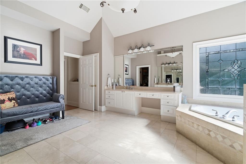 1607 Oak Grove Road Decatur, GA 30033 - Photo 24 of 71 a large en suite bathroom with a large tub and shower