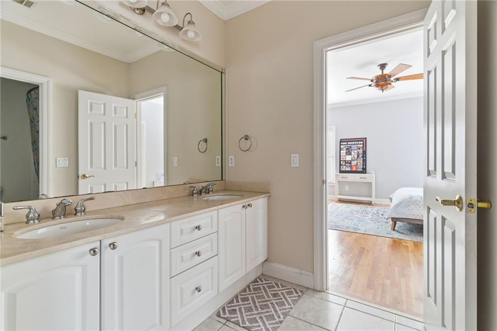 1607 Oak Grove Road Decatur, GA 30033 - Photo 29 of 71 a en suite bathroom with a granite countertop sink and a mirror
