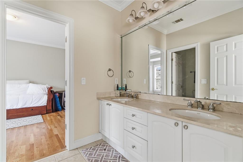 1607 Oak Grove Road Decatur, GA 30033 - Photo 33 of 71 a bathroom with a granite countertop sink mirror and vanity