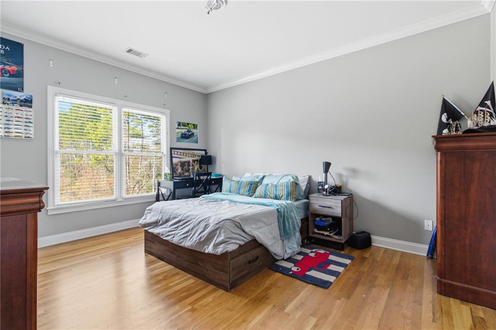 1607 Oak Grove Road Decatur, GA 30033 - Photo 34 of 71 a bedroom with a bed and a wooden floor
