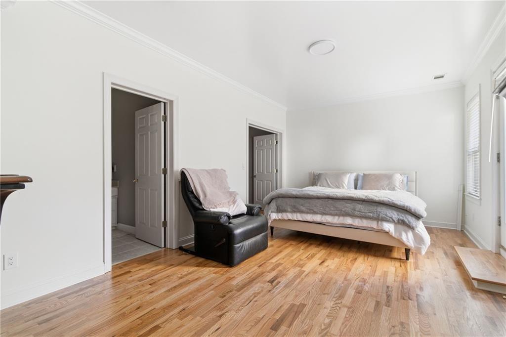 1607 Oak Grove Road Decatur, GA 30033 - Photo 44 of 71 a bedroom with a bed and wooden floor