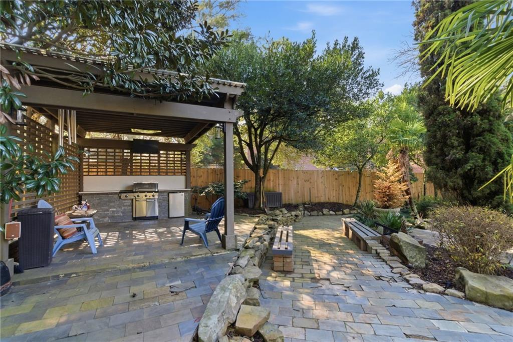 1607 Oak Grove Road Decatur, GA 30033 - Photo 54 of 71 a view of a patio with table and chairs with wooden fence and plants